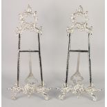 A PAIR OF SILVER PLATED EASELS. 18ins high.
