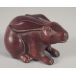 A JAPANESE CARVED WOOD RABBIT NETSUKE. Signed, 2ins.