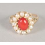 A 9CT GOLD CORAL AND PEARL RING.