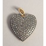 A VICTORIAN STYLE GOLD HEART SHAPED LOCKET set with rose diamonds.