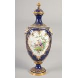 A ROYAL WORCESTER LARGE VASE painted with exotic birds in landscape on a cobalt blue ground in the