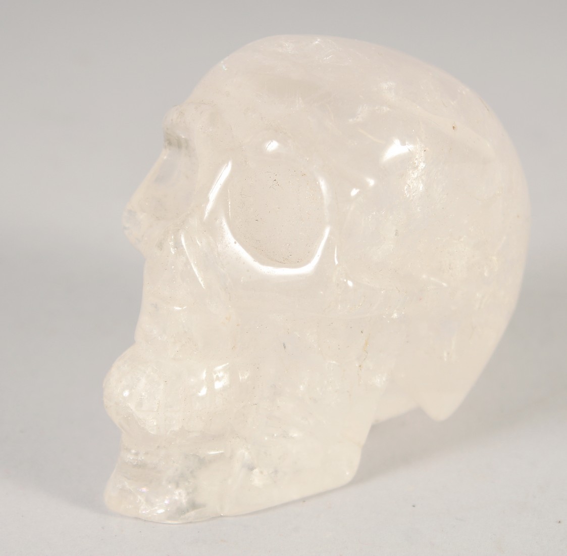 A SMALL CARVED ROCK CRYSTAL SKULL.