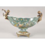 AN OVAL PORCELAIN COMPORT painted with birds and flowers with gilt cupid handles. 11ins wide.