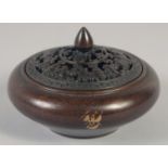 A CHINESE CIRCULAR BRONZE GOLD SPLASH CENSER AND COVER. 3.75ins diameter.