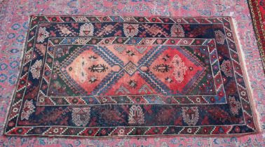 A PERSIAN CARPET, pale pink central ground stylised geometric decoration 6'7" x 4'.