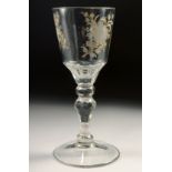AN 18TH CENTURY DUTCH WINE GLASS with facet stem, the bowl engraved with flowers. 6ins high.