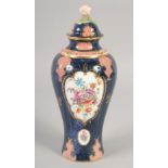 A ROYAL WORCESTER VASE AND COVER painted with flowers on a blue scale ground with red cell panels by