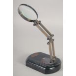 A MAGNIFYING GLASS on a stand. 9ins high.