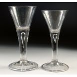 TWO 18TH CENTURY WINE GLASSES with tapering bowls and teardrop stems. 6ins and 5.5ins high.