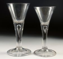 TWO 18TH CENTURY WINE GLASSES with tapering bowls and teardrop stems. 6ins and 5.5ins high.