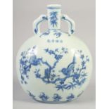 A CHINESE BLUE AND WHITE PORCELAIN MOON FLASK with twin handles and decorated with birds. 28cm