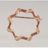 AN 18CT GOLD, DIAMOND, AND RUBY BROOCH. 2.5cm diameter.