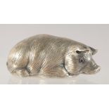 A RUSSIAN CAST SILVER MODEL OF A RECUMBENT PIG. Marks: Eagle, Head 88 I. P. Faberge. 32gms.