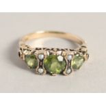 A GOOD 9CT GOLD PERIDOT AND PEARL RING.