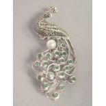 A SILVER EMERALD MARCASITE AND PEARL PEACOCK BROOCH.