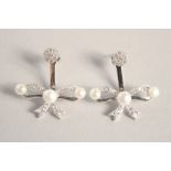 A PAIR OF SILVER BOW PEARL SET EARRINGS.