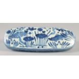 A CHINESE BLUE AND WHITE PORCELAIN SCRIBES BOX, decorated with fish and aquatic flora. 28cm long.