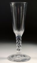 AN 18TH CENTURY DUTCH WINE GLASS with facet stem and plain bowl. 6.75ins high.