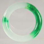 A TWO TONE JADE BANGLE. 3.75ins diameter.