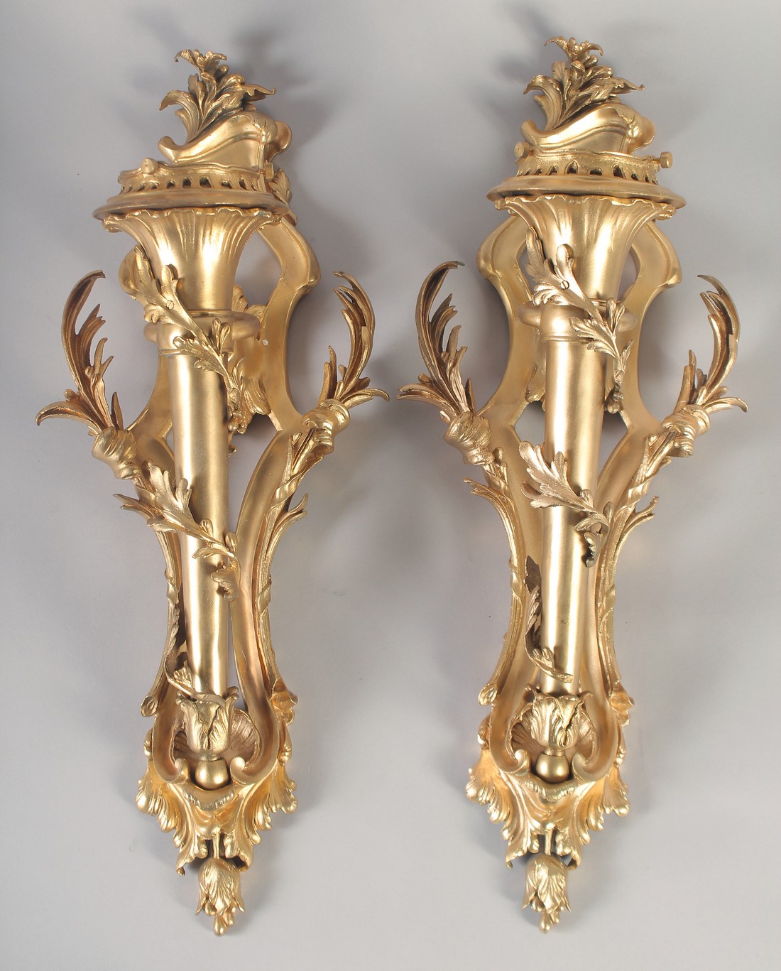 A VERY GOOD PAIR OF GILT BRONZE WALL CORNETS with acanthus scrolls and torch. 24ins long.