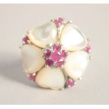 A SILVER MOTHER OF PEARL AND RUBY RING.