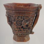 A GOOD CHINESE CARVED WOOD LIBATION CUP with handle. 5ins high.