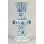 A CHINESE BLUE AND WHITE PORCELAIN GU VASE with floral decoration, six character mark to base. 33.