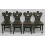 A VERY GOOD SET OF FOUR REGENCY HALL CHAIRS with carved shaped backs with crest, solid seats on