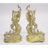 A GOOD PAIR OF 19TH CENTURY CAST BRASS CHENETS with acanthus decoration. 1ft 1ins high, 9ins wide.