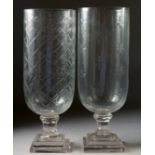 TWO CUT GLASS STORM LAMPS on square stepped bases. 15ins high.