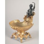 A GILT BRONZE AND BRONZE SALT with a cherub. 6.5ins.