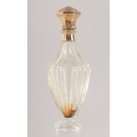 A CUT GLASS SCENT BOTTLE WITH HINGED GOLD TOP. 10cm high.