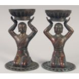 A PAIR OF TIBETAN GILT BRONZE CANDLESTICKS. 23cm high.