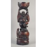 A CARVED ROSEWOOD BUDDHA. 26ins long.