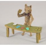 A SMALL VIENNA BRONZE, fox playing cards. 4ins long.