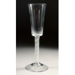 AN 18TH CENTURY TALL PLAIN ALE GLASS with air twist stem. 7.75ins high.