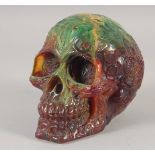 A CARVED AMBER STYLE SKULL.