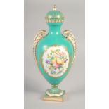 A 19TH CENTURY COALPORT VASE AND COVER painted with fruit and flowers on a blue green ground by