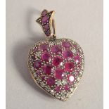 A 9CT GOLD RUBY AND DIAMOND HEART SHAPED LOCKET.