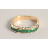 AN 18CT GOLD EMERALD AND DIAMOND THREE ROW RING.