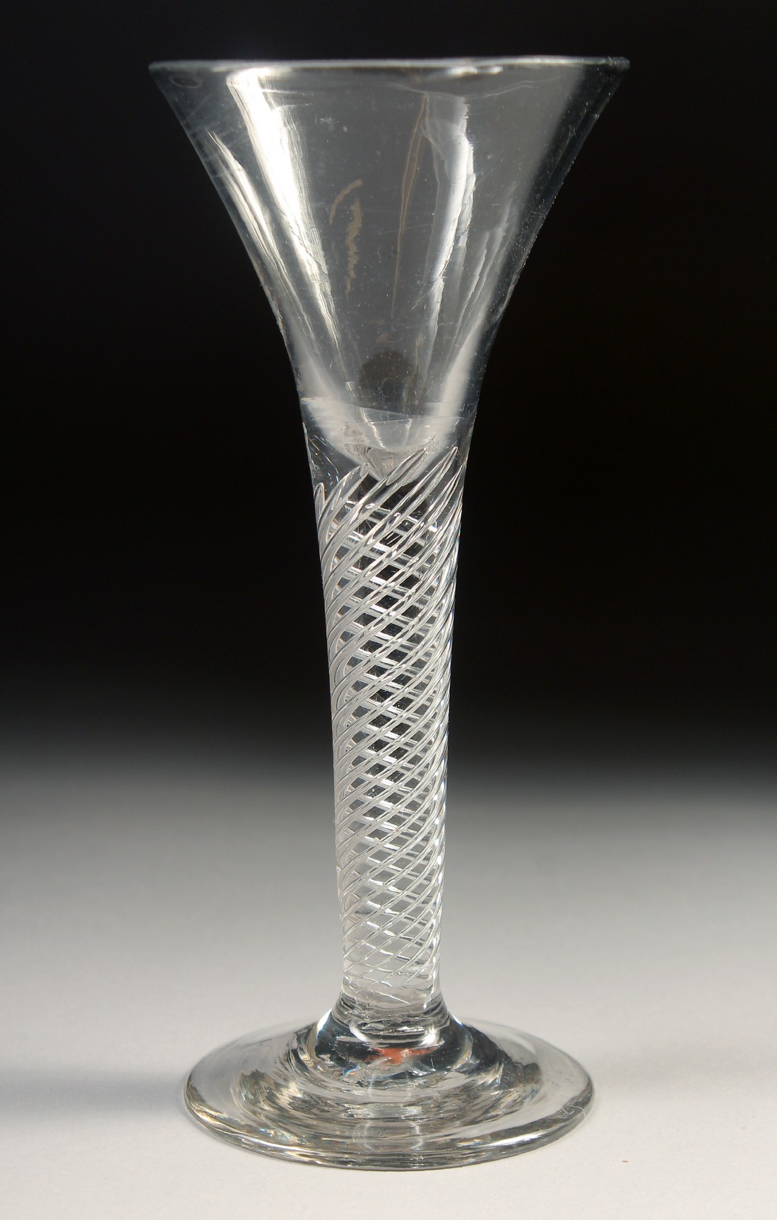 AN 18TH CENTURY TAPERING WINE GLASS with air twist stem. 6ins high.