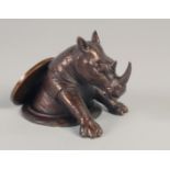 A CHINESE CIRCULAR BRONZE RHINO. 4ins.