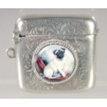 AN EDWARD VII SILVER VESTA CASE with an oval enamel of a pug dog. 1.5ins x 1.25ins. Chester 1918.