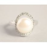 A SILVER PEARL RING.