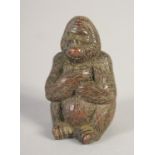 A SMALL JAPANESE BRONZE SEATED GORILLA. 1.75ins high.