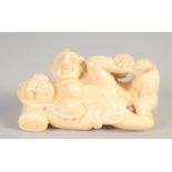 A SMALL CARVED BONE EROTIC NETSUKE. 2ins.