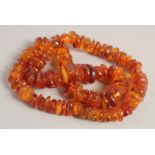 AN AMBER NECKLACE. 26ins long.