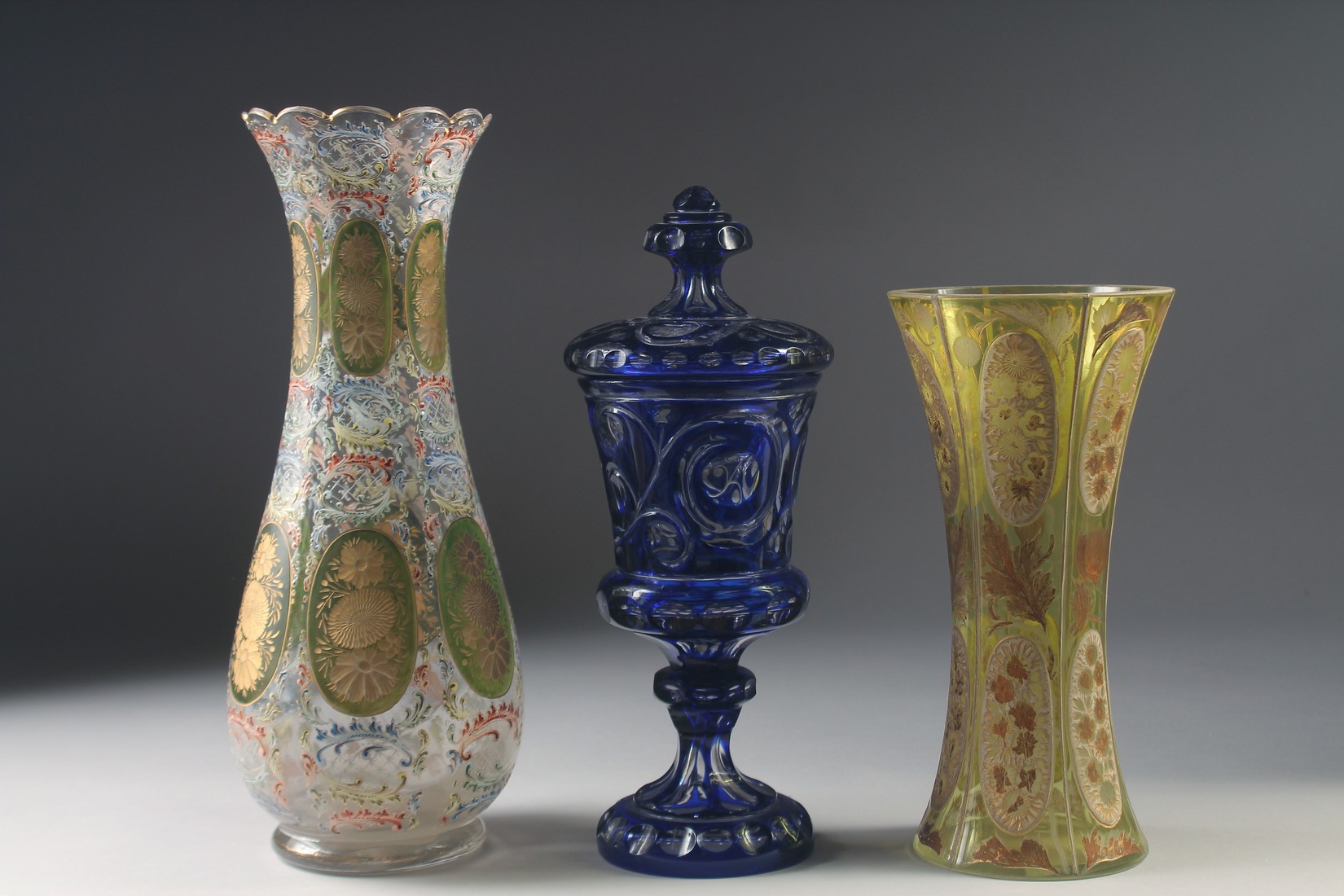 THREE VARIOUS BOHEMIAN GLASS VASES one with a cover. 13ins, 10ins & 9.5ins high. - Image 2 of 6