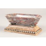A GOOD SMALL GRAND TOUR MARBLE BATH, on a brass bound marble base. 6.5ins long,