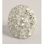 A SUPERB ART DECO PLATINUM AND DIAMOND OVAL PIERCED CLUSTER RING. 2.5cm x 2cm.